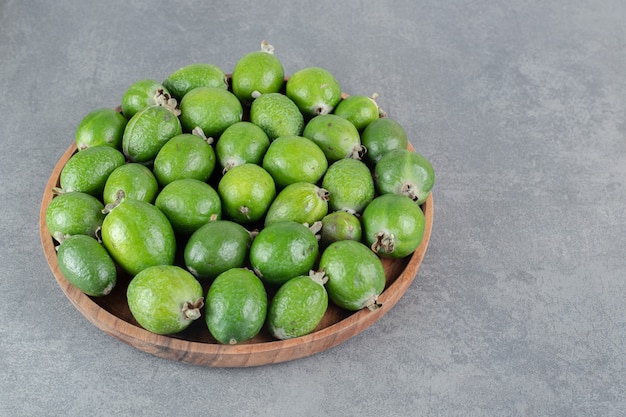 Fresh feijoa fruits on wooden plate. High quality photo