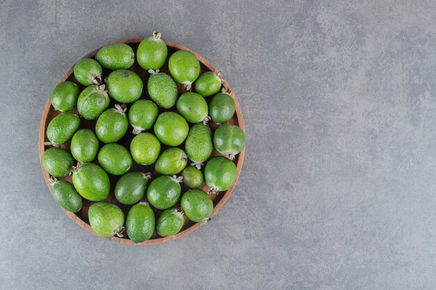 Fresh feijoa fruits on wooden plate. High quality photo
