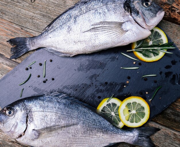 fresh Fish with lemon on rustic board