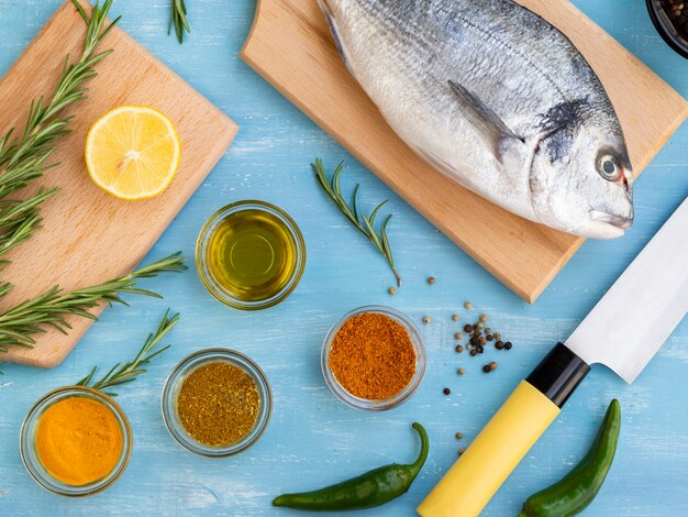 Fresh fish on a wooden board ready to be cooked