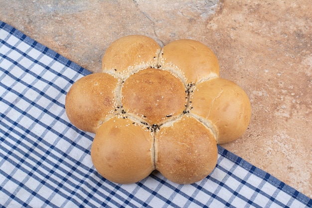 Fresh flower shaped bread on marble background