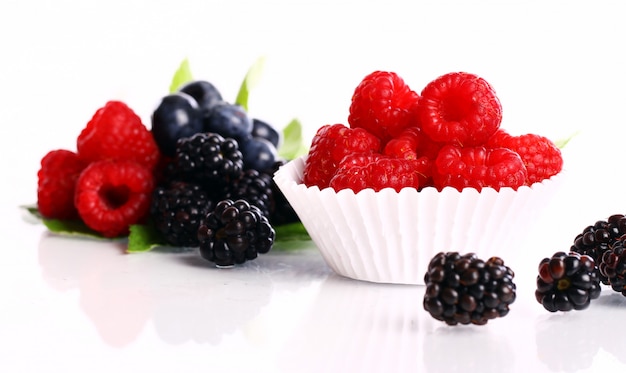 Fresh forest berries over white