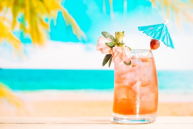 Fresh fruit drink with ice cubes in decorated glass