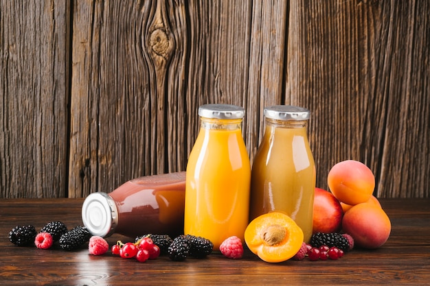 Fresh fruit smoothies on wooden background