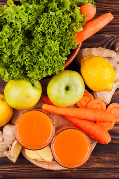 Fresh fruit and vegetables with juice on table