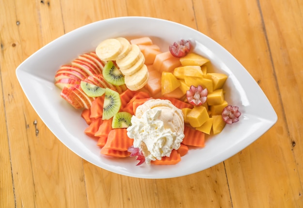 Fresh fruits ice cream on wood table .