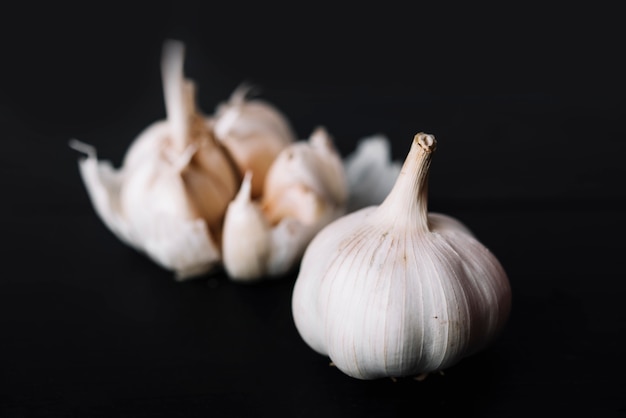 Fresh garlic bulb on black surface