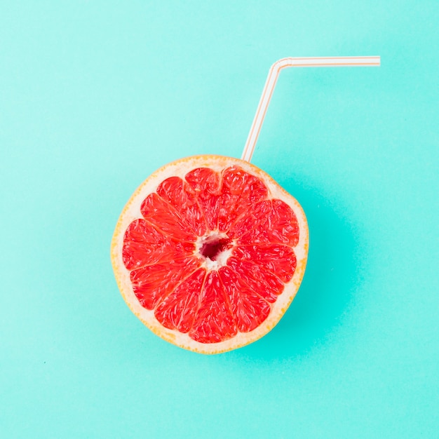 Fresh grapefruit with straw