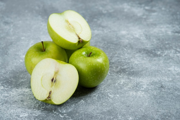 Fresh green apples on marble background.