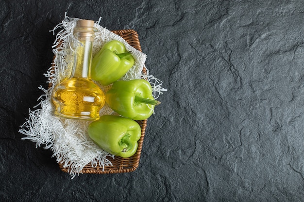 Fresh green bell peppers on black.