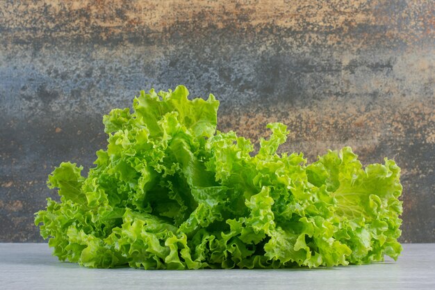 Fresh green lettuce on marble background. High quality photo