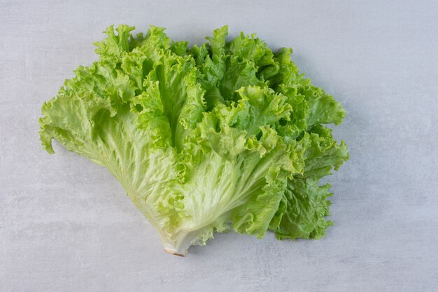 Fresh green lettuce on marble background. High quality photo