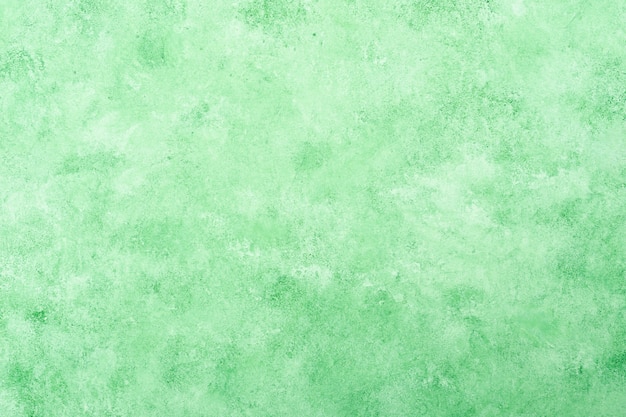 Free photo fresh green textured stucco wall background