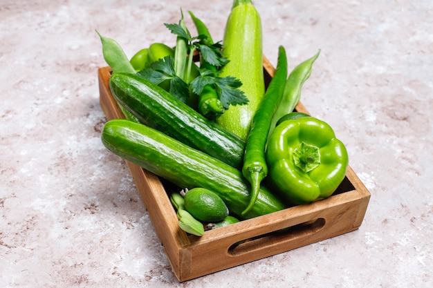 Fresh green vegetables on concrete surface