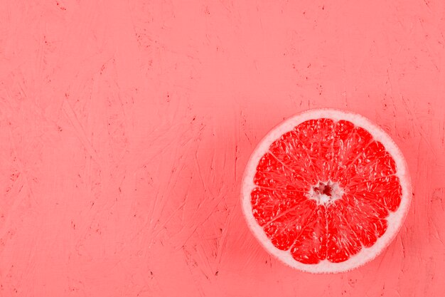 Fresh halved grapefruit on textured background