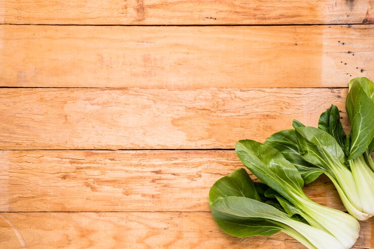 Free Photo fresh harvested bokchoy on the corner of the wooden table