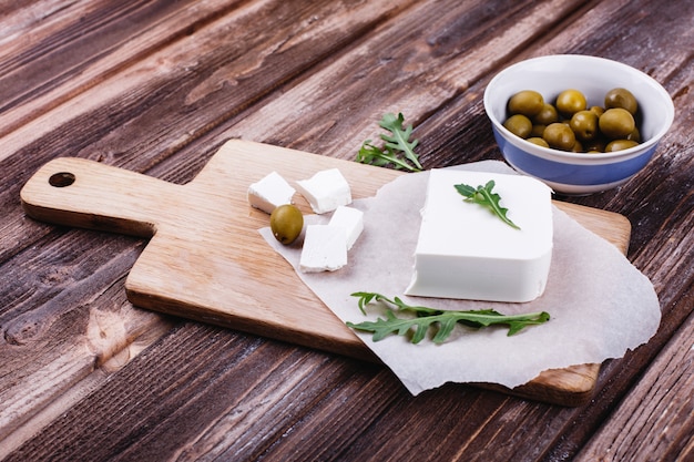 Fresh and healthy food. Delicious Italian dinner. Fresh cheese served on wooden board 