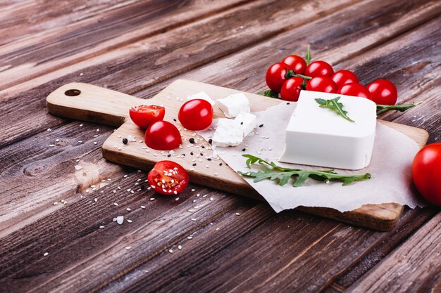 Fresh and healthy food. Delicious Italian dinner. Fresh cheese served on wooden board 