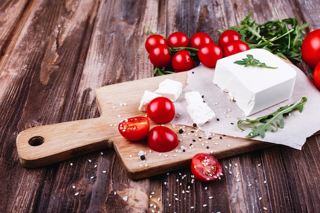 Fresh and healthy food. Delicious Italian dinner. Fresh cheese served on wooden board 