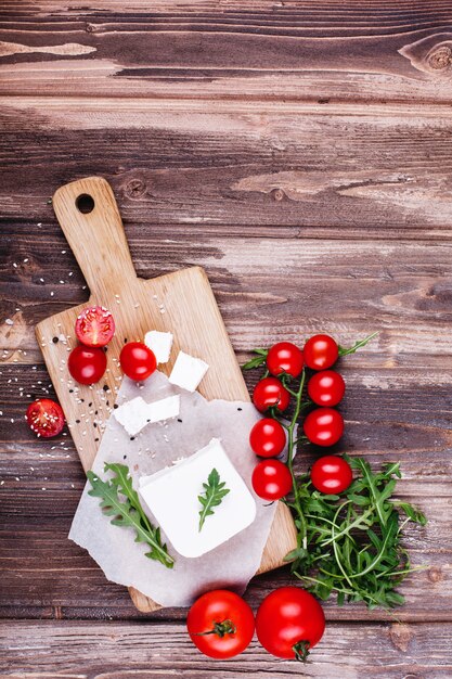 Fresh and healthy food. Delicious Italian dinner. Fresh cheese served on wooden board 