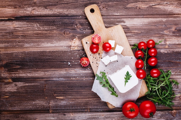 Fresh and healthy food. Delicious Italian dinner. Fresh cheese served on wooden board 