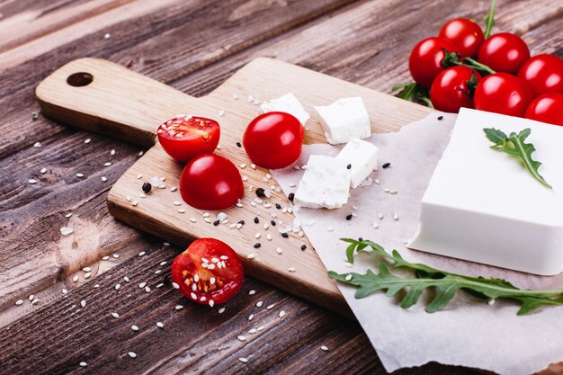 Fresh and healthy food. Delicious Italian dinner. Fresh cheese served on wooden board 