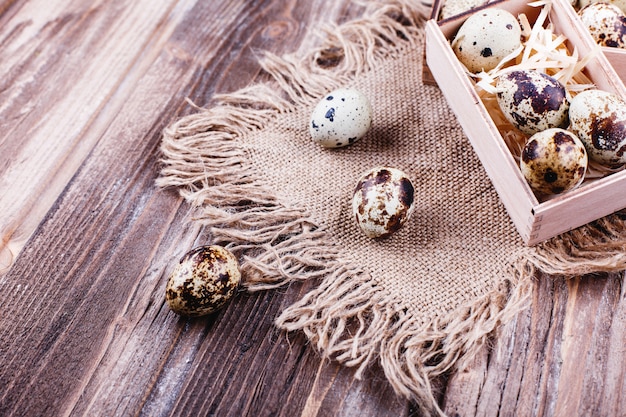 Fresh and healthy food, protein. Quail eggs in wooden box stand on the rustic table