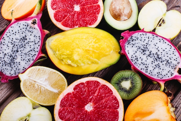 Fresh and healthy food, vitamins. Pieces of dragon fruit, pomelo, lemons, lime, avocado