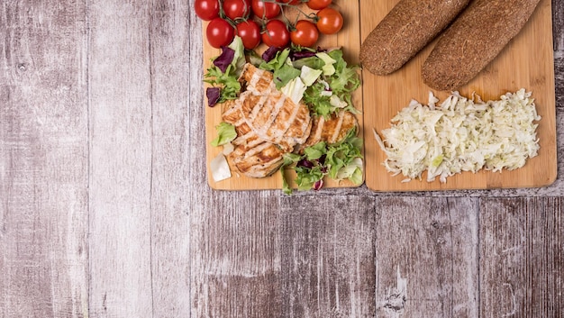 Fresh healthy grilled chicken and tomatoes on wooden boards. Healthy lifestyle