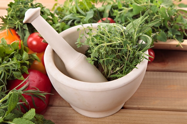 Fresh herbs with a mortar and pestle