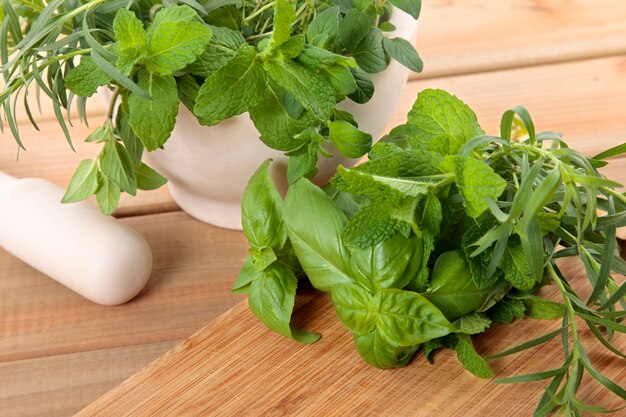 Fresh herbs with a mortar