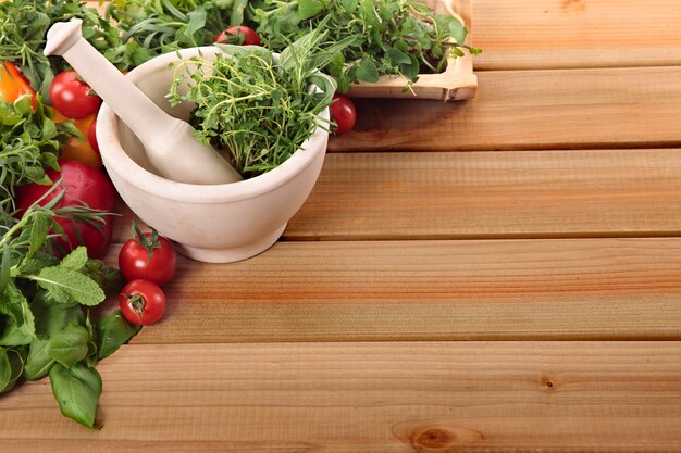 Fresh herbs with a mortar