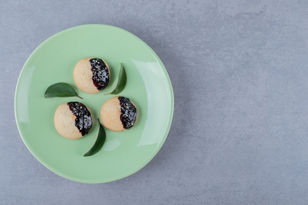 Fresh homemade cookies on green plate