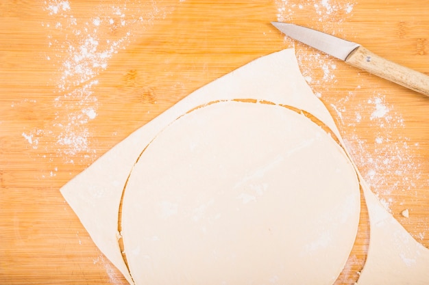 Fresh homemade dough on wooden table