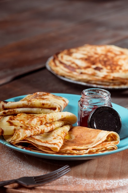 Fresh homemade french crepes made with eggs, milk and flour, filled with marmalade on a vintage plate