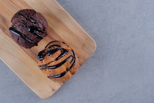 Fresh homemade muffins. Chocolate sauce. Top view