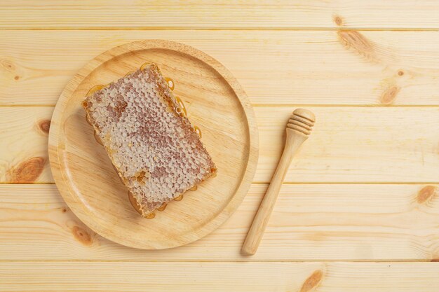 Fresh honeycombs on wooden surface