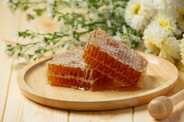 Fresh honeycombs on wooden surface