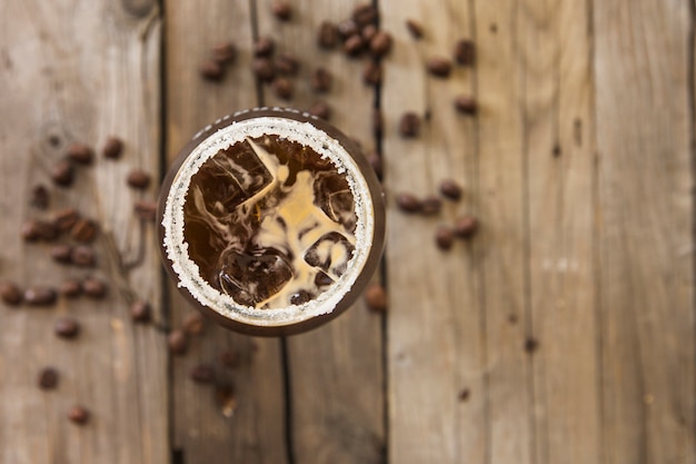 Fresh ice coffee on wooden background