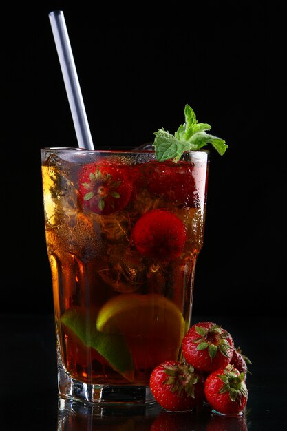 Fresh ice tea with ice and strawberries