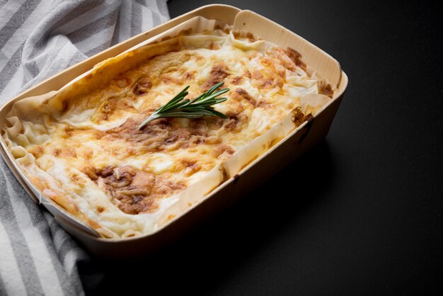 Fresh italian lasagna and table cloth on kitchen counter