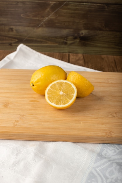 Fresh juicey lemons on a wooden board