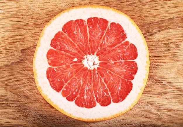Fresh juicy grapefruit slices on wooden