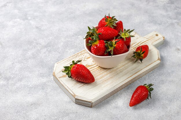 Fresh juicy strawberries on light background,top view