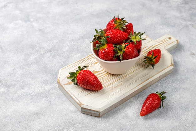 Fresh juicy strawberries on light background,top view