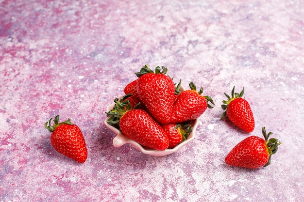 Fresh juicy strawberries on light background, top view