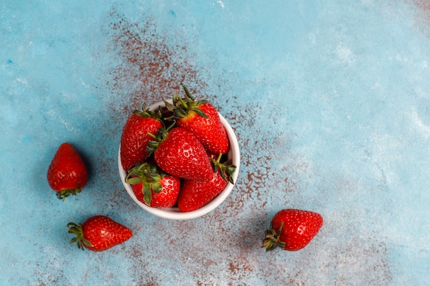 Fresh juicy strawberries on light background, top view