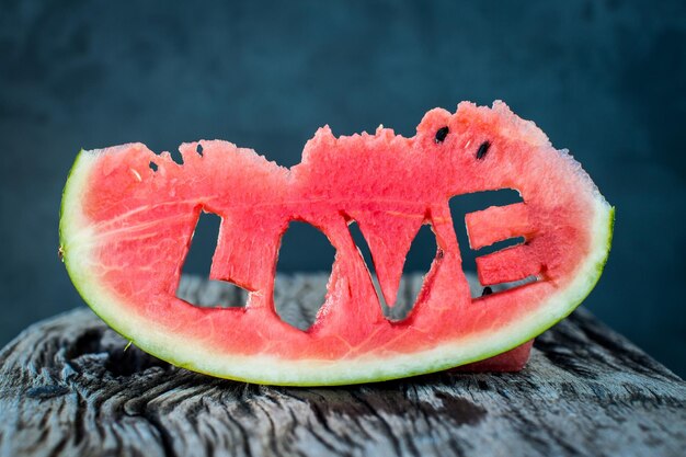 Fresh juicy watermelon slice closeup with love letters word