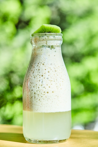 Fresh kiwi lemonade on wooden table