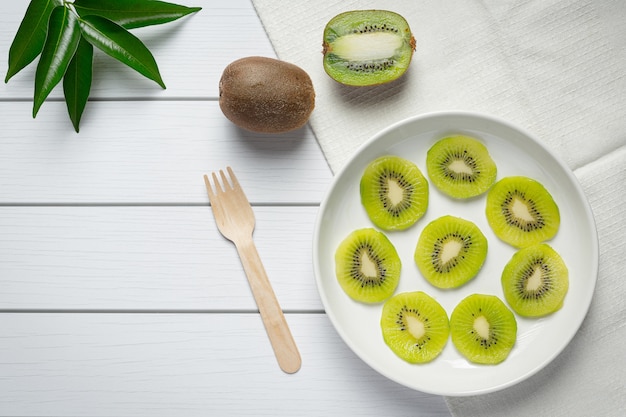 Fresh kiwi, slide into pieces, put on white plate